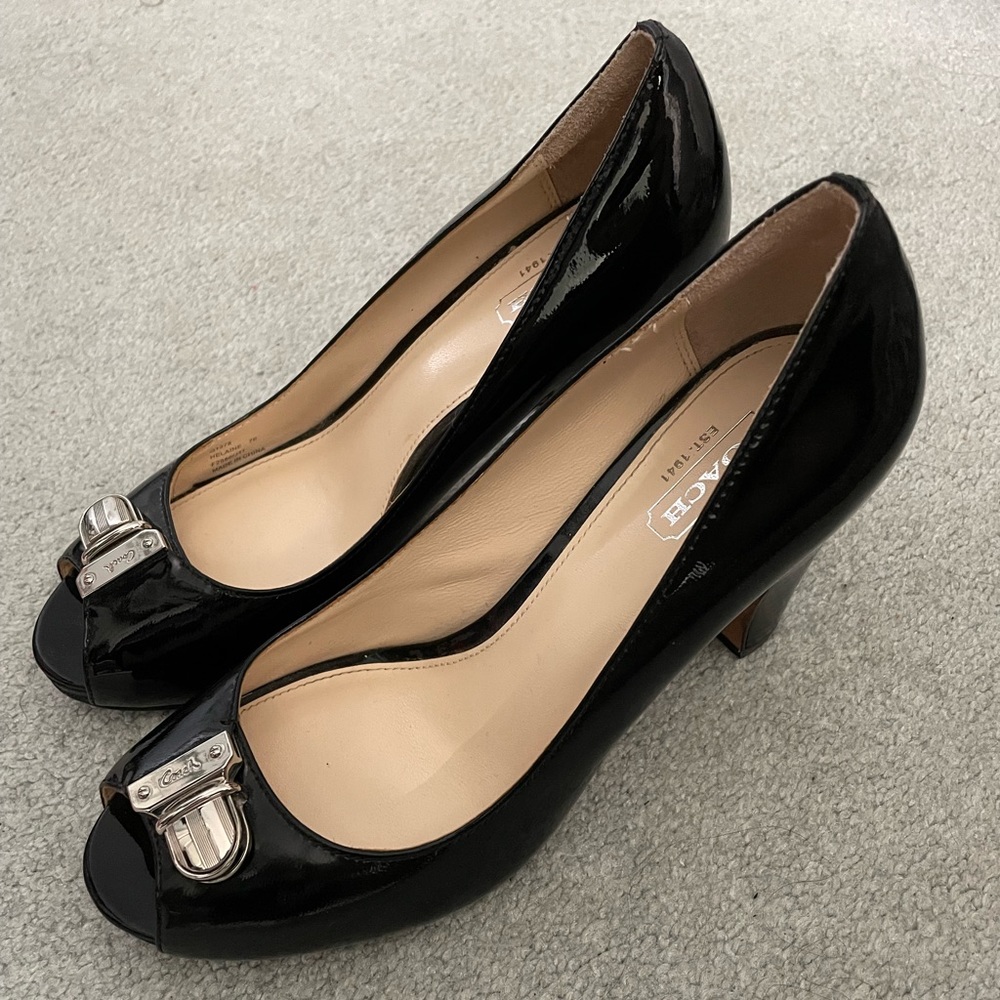 Beautiful Coach never worn black patent leather pumps with silver hardware.